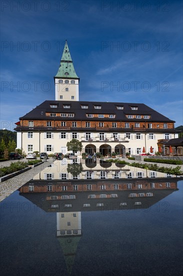 Schloss Elmau castle hotel with tower reflected in the fountain
