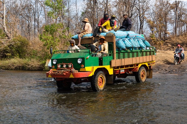 Truck crossing the river at the Bousra waterfall