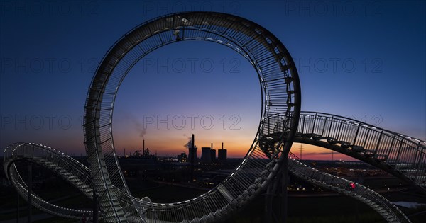 Power plant with part of the Tiger and Turtle sculpture at sunset
