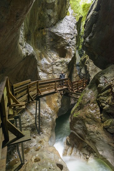 Wooden boardwalk in gorge with stream