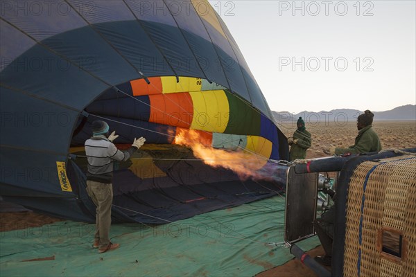 Pilot inflating hot air balloon with two burners