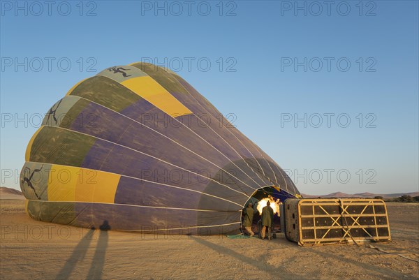 Pilot inflating hot air balloon with two burners