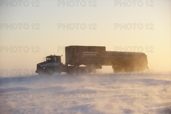Truck transporting goods on the snowy Dalton Highway in the middle of the Arctic winter