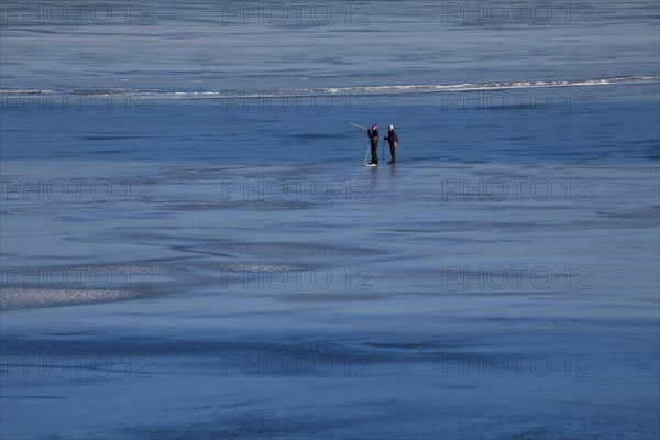 Elderly couple ice skating on frozen Glafsfjorden