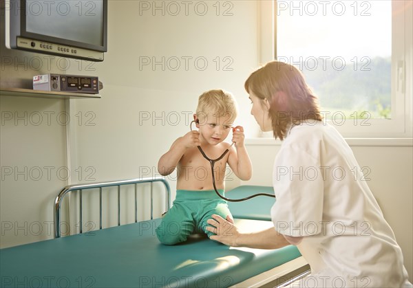 Pediatrician examining boy