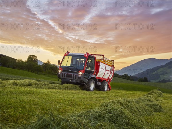 Unitrac transporter with forage trailer collecting the dried grass