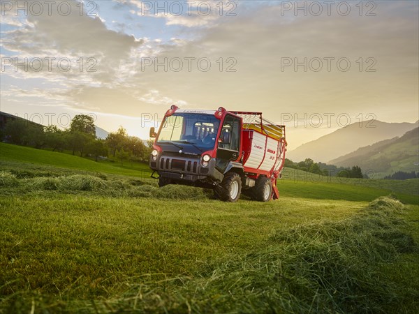 Unitrac transporter with forage trailer collecting the dried grass