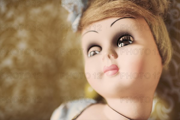 Face of an old fashioned doll looking away with a bored expression