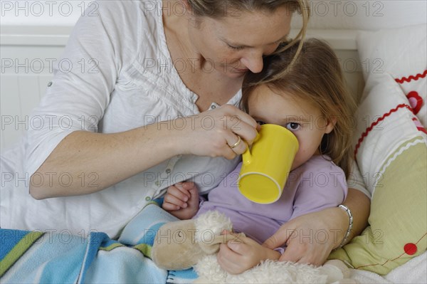 Mother taking care of her sick daughter