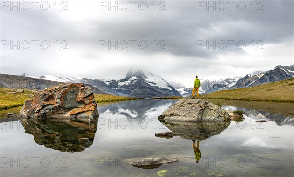Hiker standing on rocks in the lake
