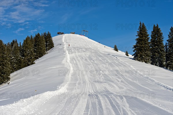Empty ski slope under a blue sky