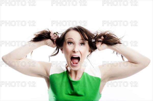 Screaming woman tearing at her own hair