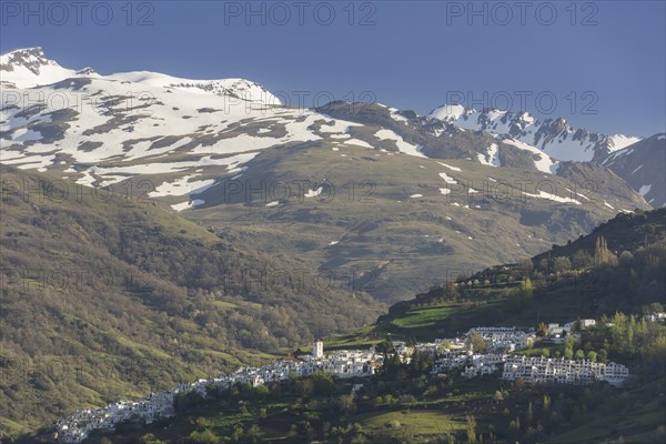 View over the town of Pampaneira towards the snow-capped Sierra Nevada Mountains