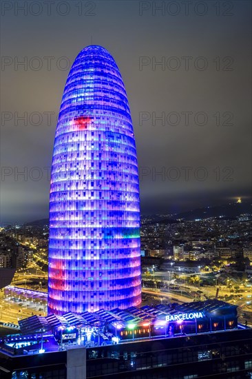 Blue illuminated Agbar Tower and city at Night