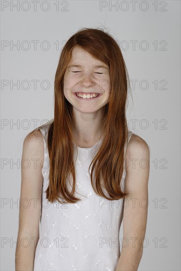 Girl laughing with her eyes closed