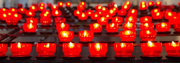 Burning votive candles in a church