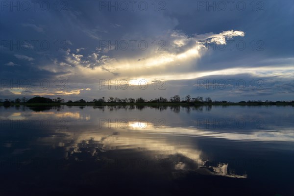 Dusk at a lake-like widened part of the Amazon or Rio Solimoes