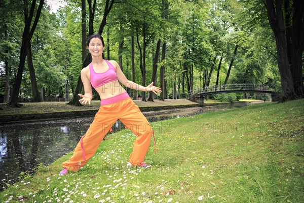 Woman dancing zumba in a park