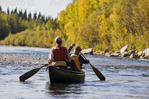 Men rowing a canoe