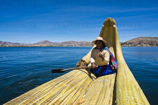 Local in a traditional rowing boat of Totora reed on Lake Titicaca