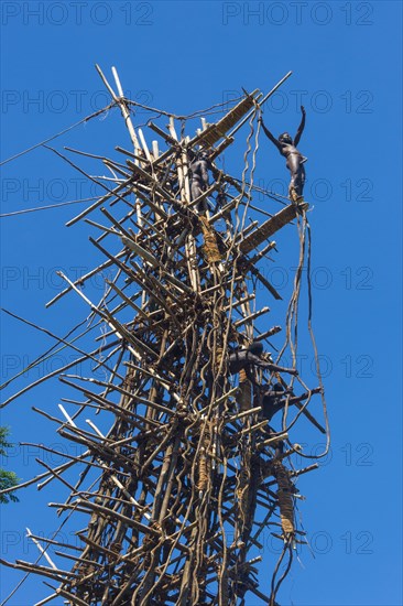 Man jumping from a bamboo tower