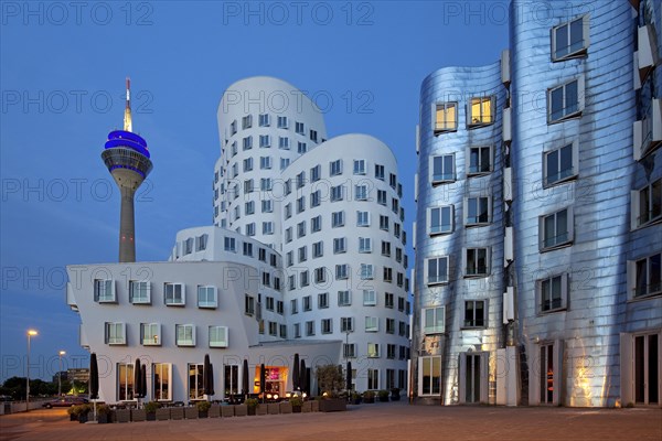 Rheinturm or Rhine Tower with two of the Gehry buildings at Neuer Zollhof