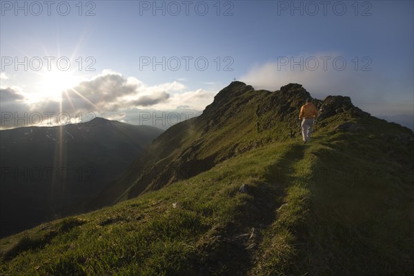 Hiker on the summit of Mt Grosser Galtenberg in the evening light