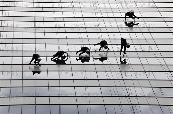 Window cleaners cleaning a glass facade