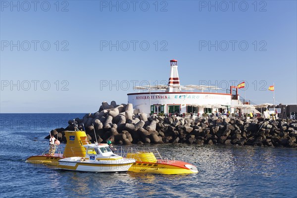 Submarine Yellow Submarine in front of lighthouse