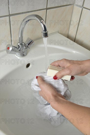 Washing by hand with German curd soap in a washbasin