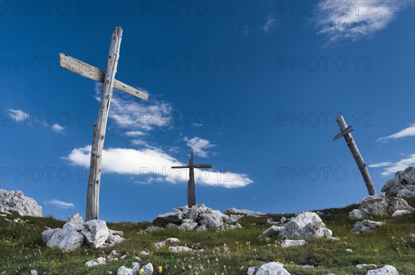 Three simple wooden crosses from World War I on a hill