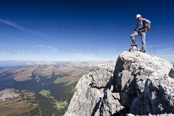 Mountain climber on the summit of Cima di Vezzana Mountain