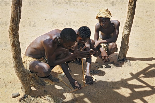 Three local men making fire