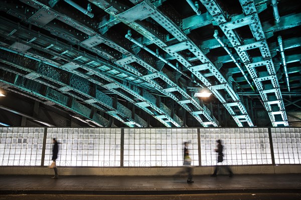 Pedestrians in an illuminated underpass