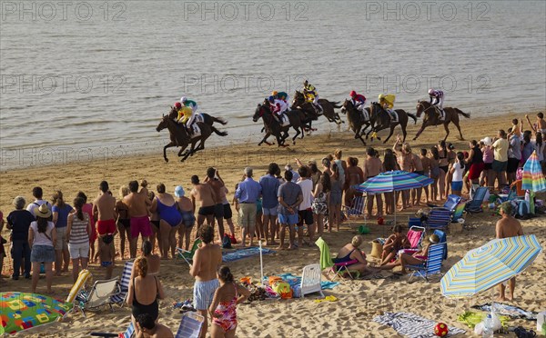 Horse race at the beach of Sanlucar de Barrameda at the Guadalquivir river mouth