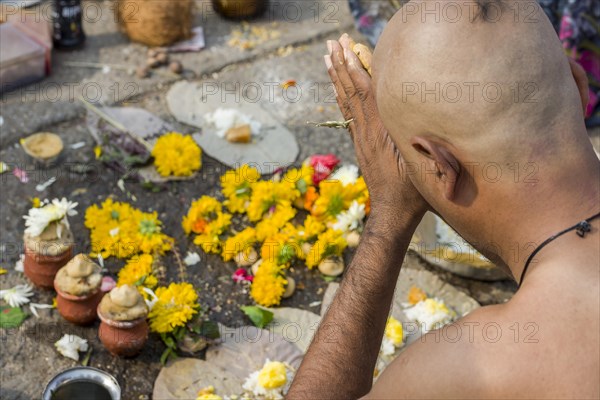 A man is praying during Dashkriya or Asthi Visarjan