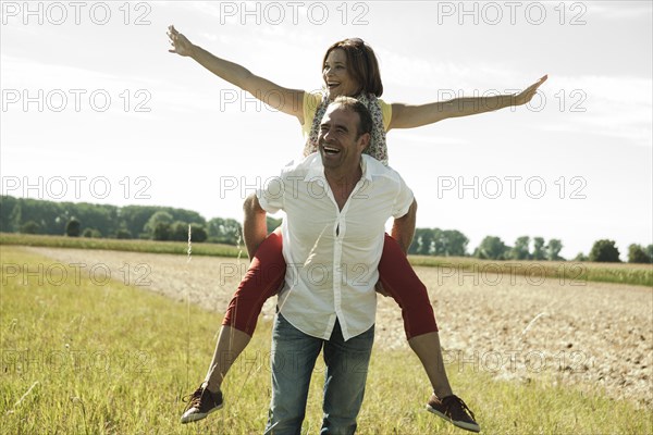Man giving a woman a piggyback ride