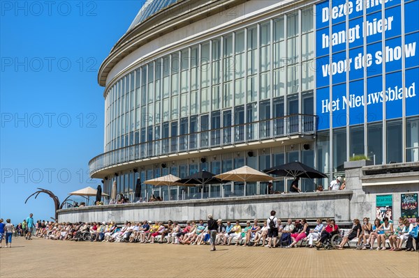People sunbathing in front of the Oostende Casino
