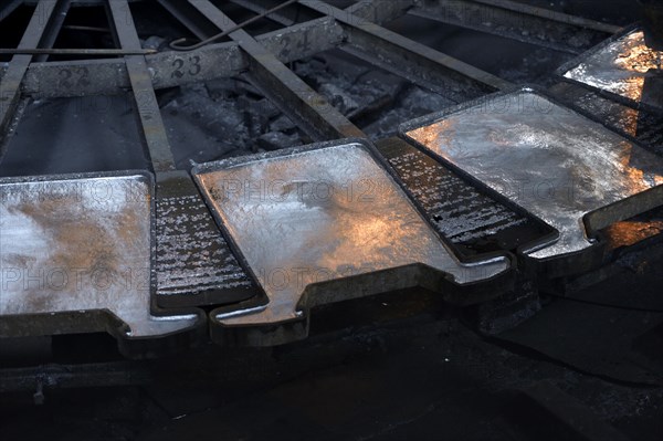 Liquid silver is being poured into molds