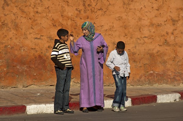 Mother in traditional dress with djellaba and headscarf