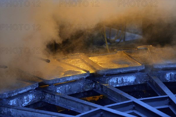 Liquid silver is being poured into molds