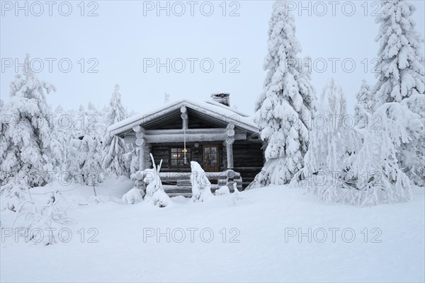 Finnish log cabin in the snow-covered landscape