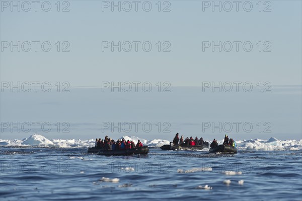 Tourists in inflatable boats