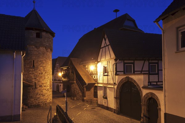Historical Town Hall with a fortified wall and the tower of a fortified church