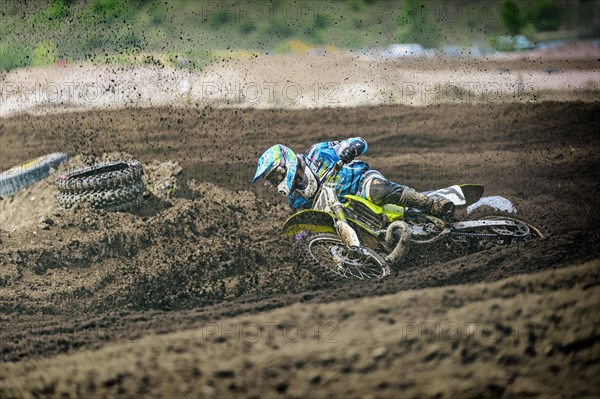 Motocross rider falling in a curve