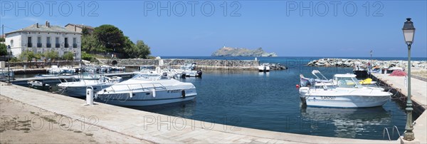 The marina of Macinaggio with the barrier island La Giraglia