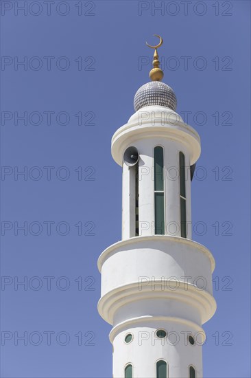 Minaret with a golden crescent moon