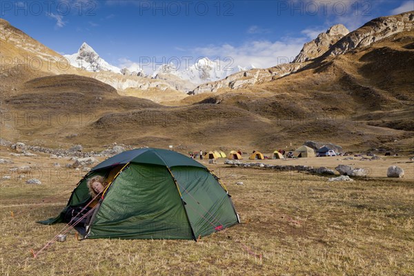 Woman looking out of a tent