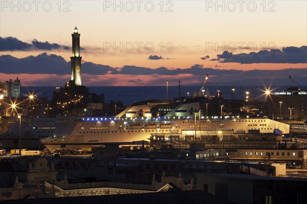 The Lighthouse of Genoa with cruise ship in the Porto Antico harbour