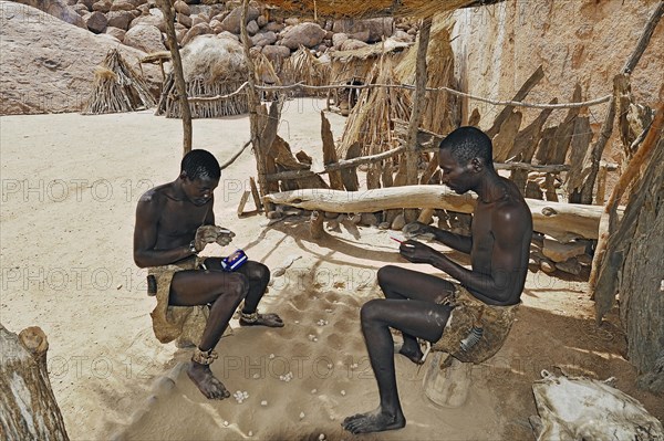 Two local men rolling cigarettes
